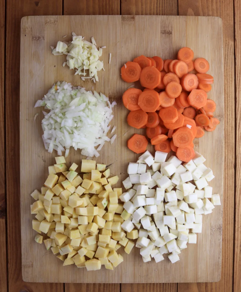 step four: chopping the other vegetables; garlic, onions, carrots, kohlrabi and celery root.