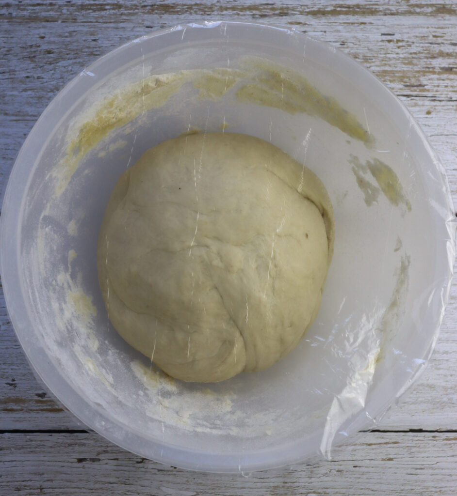 how to place the dough in the bowl and cover it with plastic wrap to rest it in the refrigerator