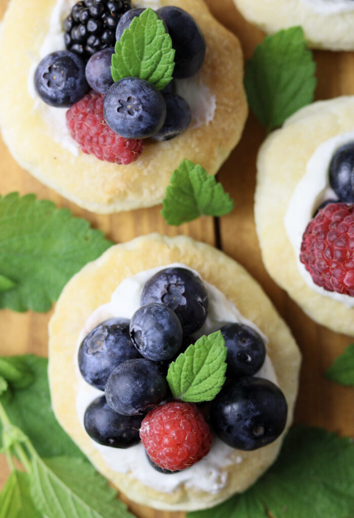 a close image of adorable fruit tarts with puff pastry from above 