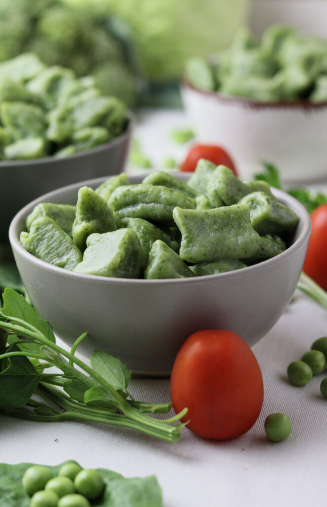 Image of served green gnocchi with wild spinach