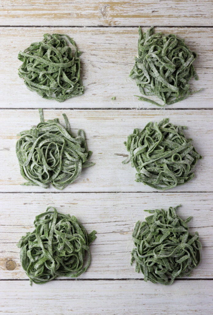 how to lay the green pasta noodles into small nests on flour-sprinkled surface before cooking or drying 