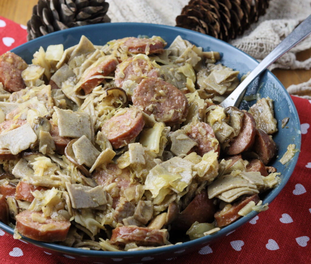 Lazanki pasta with sweet cabbage, sauerkraut, cabbage, bacon and sausage